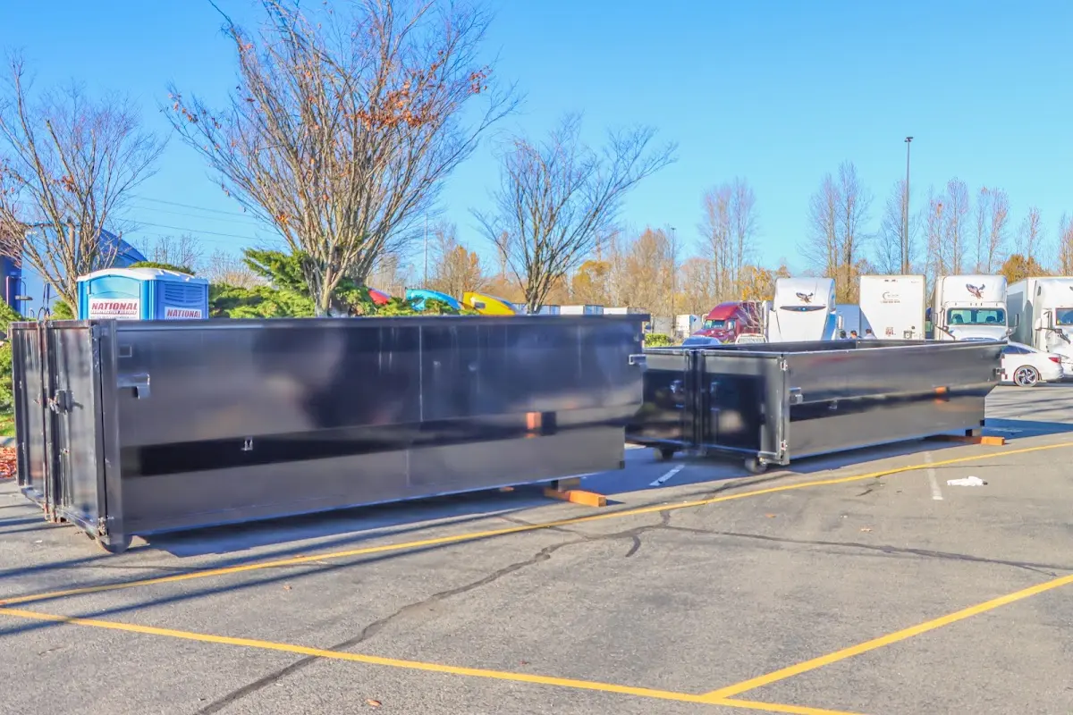 Professional dumpster rental service with roll-off container on residential driveway in Gustine